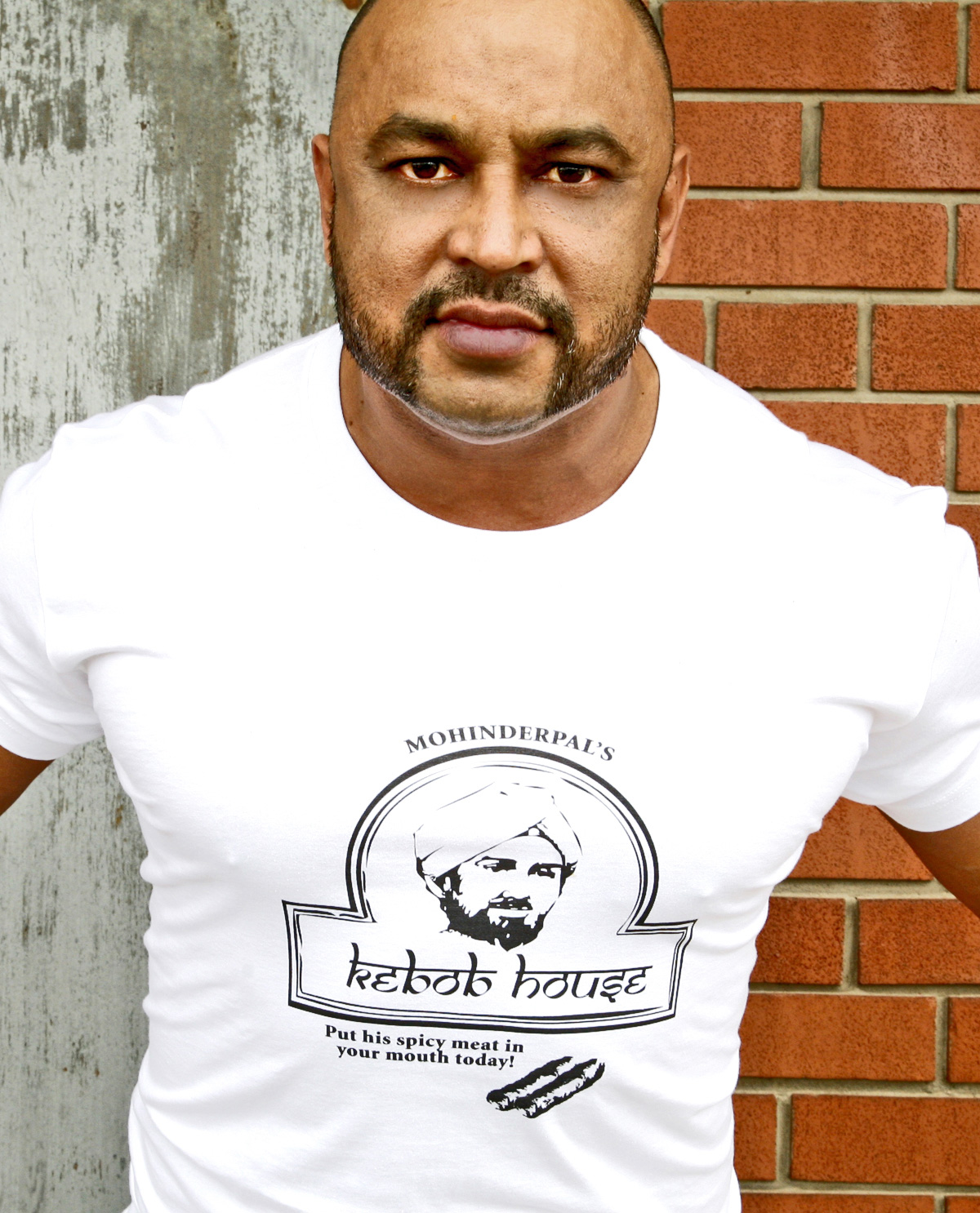 South Asian male model wearing white American Apparel t.shirt with silkscreened image of Indian restaurant design on front. South Asian Desi Themed Graphic Design t-shirt collection by Brown Man Clothing Co.