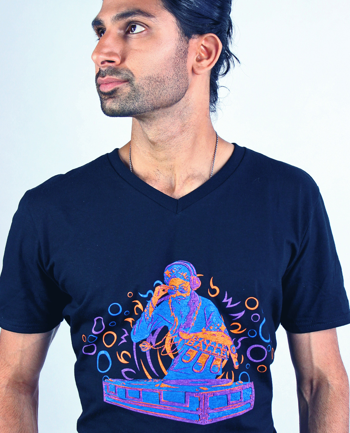 South Asian male model wearing DJ Singh Spin  black V neck graphic design t.shirt printed super Gildan SoftStyle t.shirt. South Asian Desi Themed Graphic Design t.shirts by Brown Man Clothing Co.