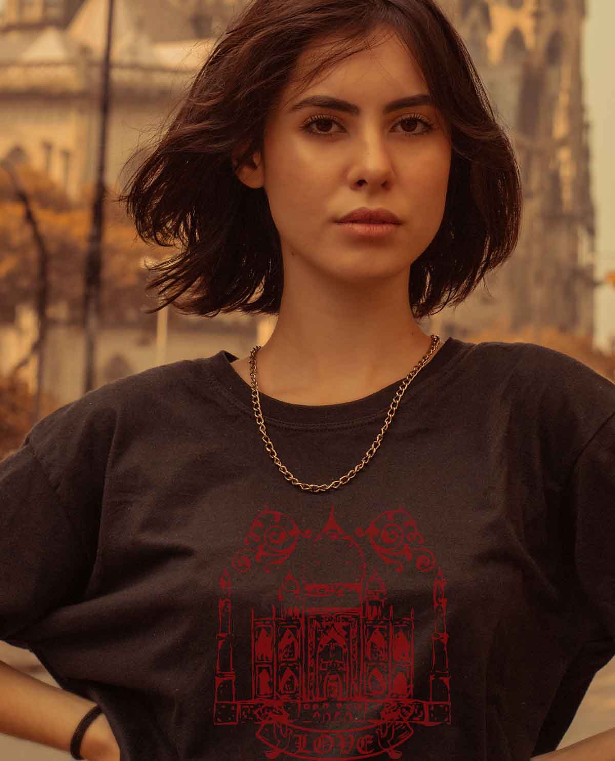 South Asian female model wearing black fitted graphic design t.shirt with image of Taj Mahal on front. Designed by Brown Man Clothing Co.